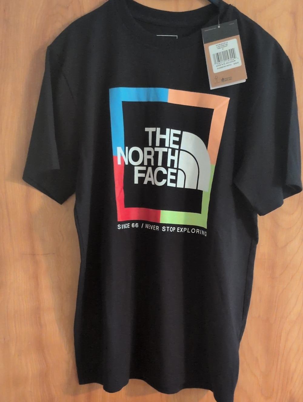 The North Face Menโs Black Tee with Blue, Orange, Red and Green Framed Logo
